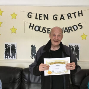 resident with award certificate
