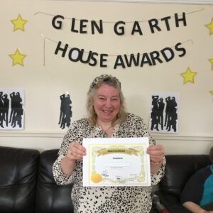 resident with award certificate