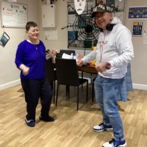 2 residents dancing in kitchen