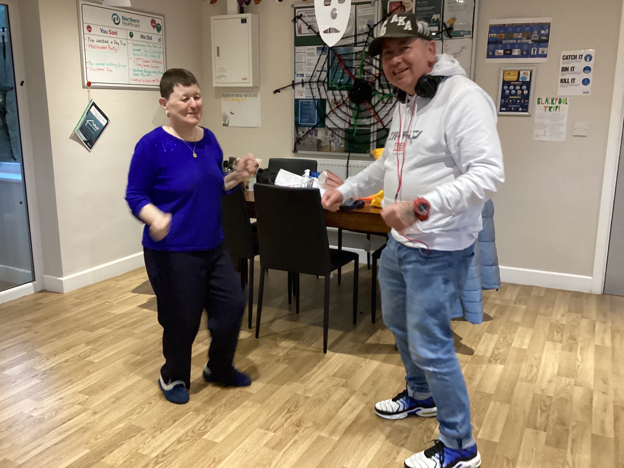 2 residents dancing in kitchen