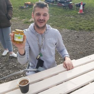 resident with pot of honey