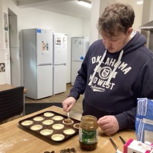 resident adding filling to mince pies
