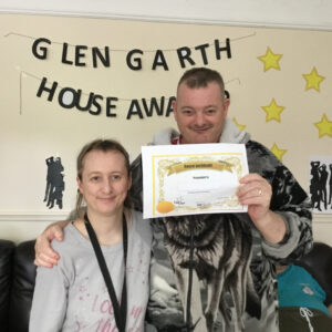 resident with award certificate