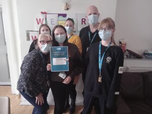 Helena's House team picture with award certificate