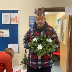 resident holding Christmas wreath