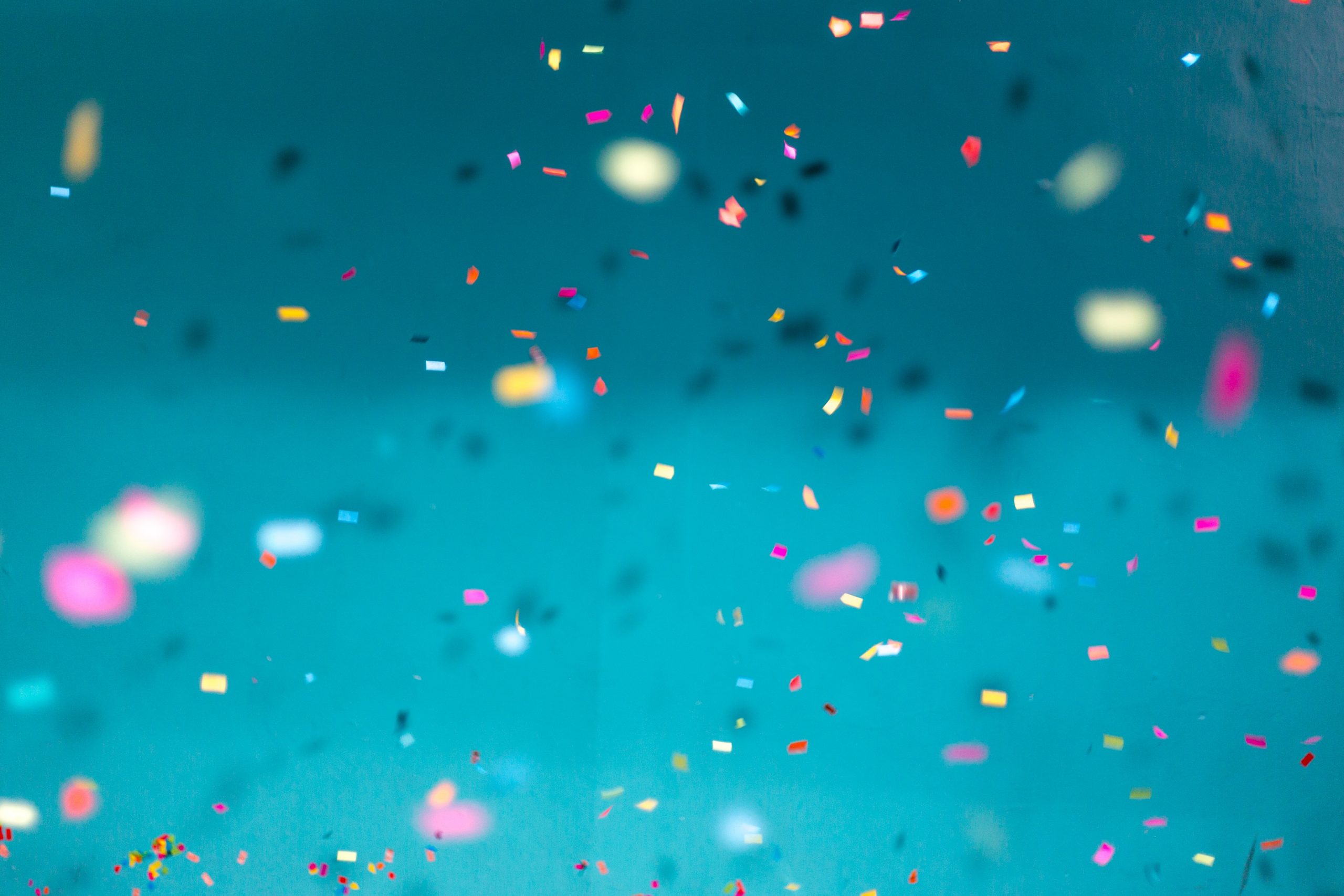 multi-coloured confetti on a blue background
