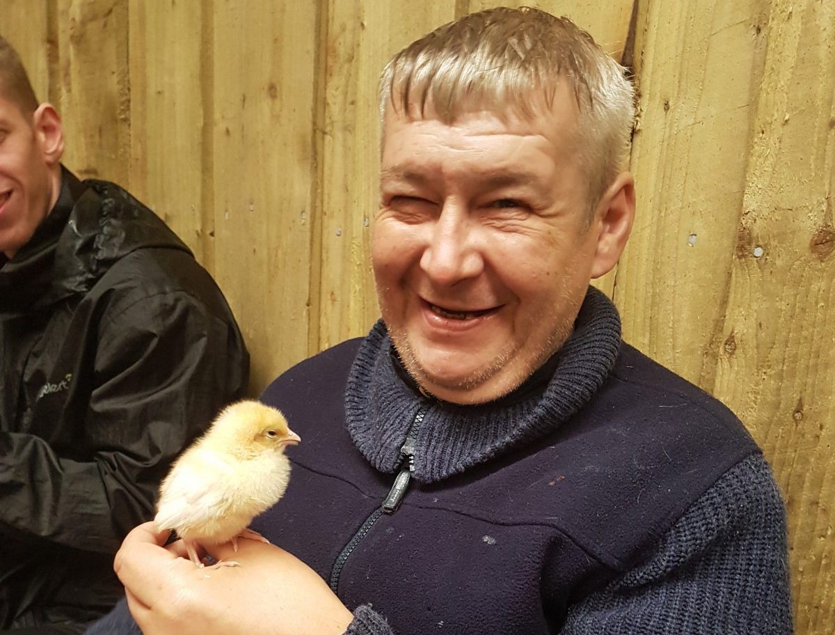 resident holding a chick