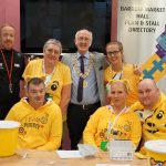 residents and team members dressed in yellow jumpers and pudsey ears