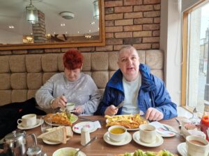 female and male resident enjoying fish and chips