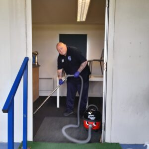 male hoovering carpet