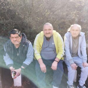 3 male residents sat on bench