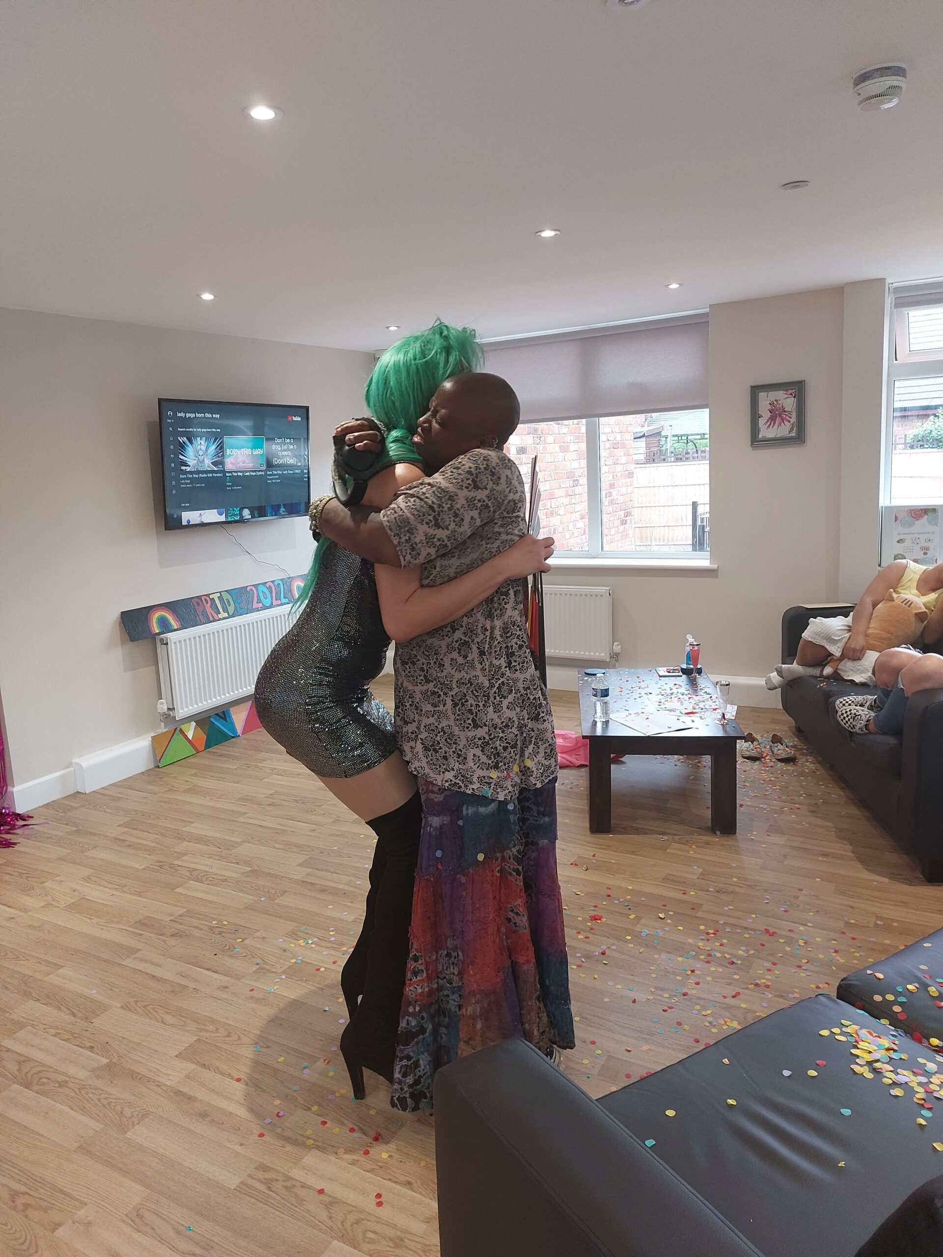 female and drag queen hugging