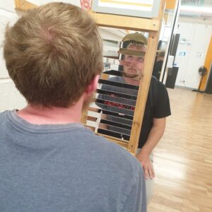 two residents looking into mirrored attraction