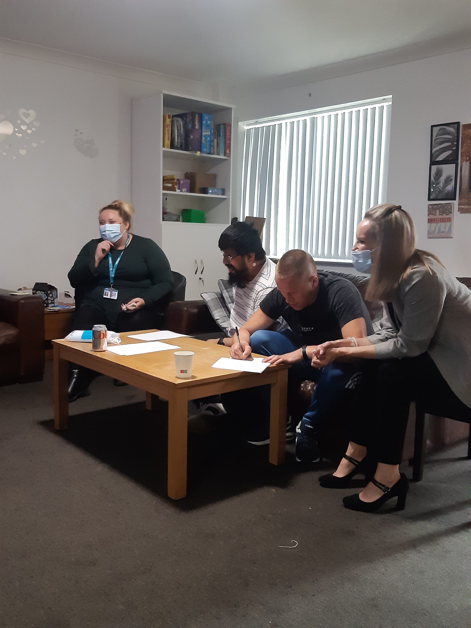 team members and residents writing down quiz question answers in group