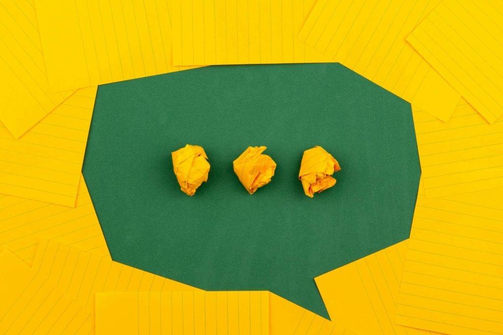 Speech bubble made of green and yellow paper for a blog on talking about mental health in supported living.