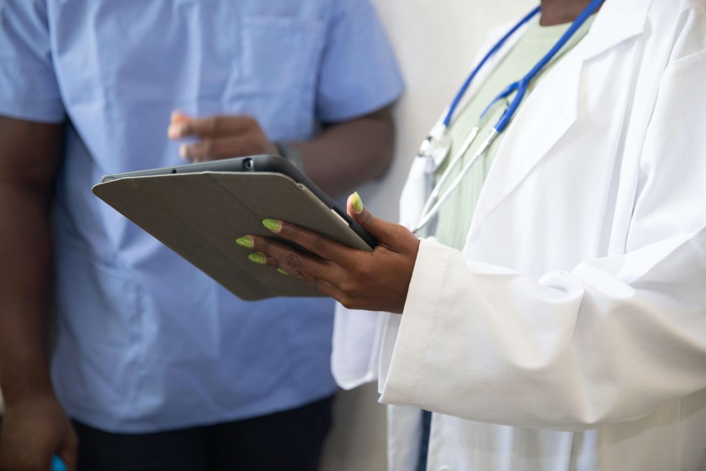 Medical staff looking at a tablet for a blog on what happens after a Section 117 aftercare placement ends