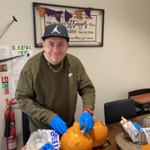 resident carving pumpkin