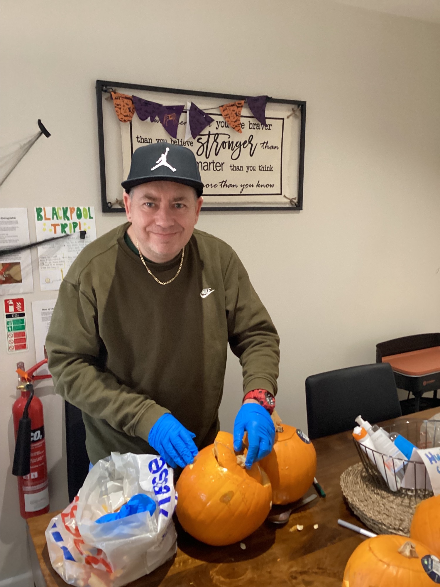 resident carving pumpkin