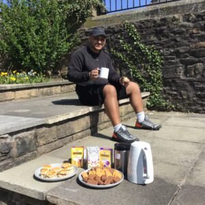 resident enjoying tea and biscuits outdoors