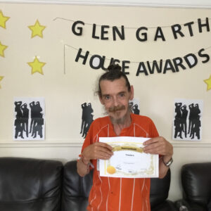 resident with award certificate