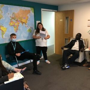 resident hosting a quiz to group of people