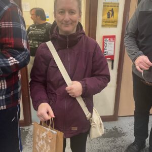 resident holding Christmas shopping bag
