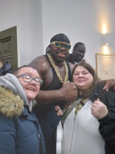 Residents posing with a wrestler