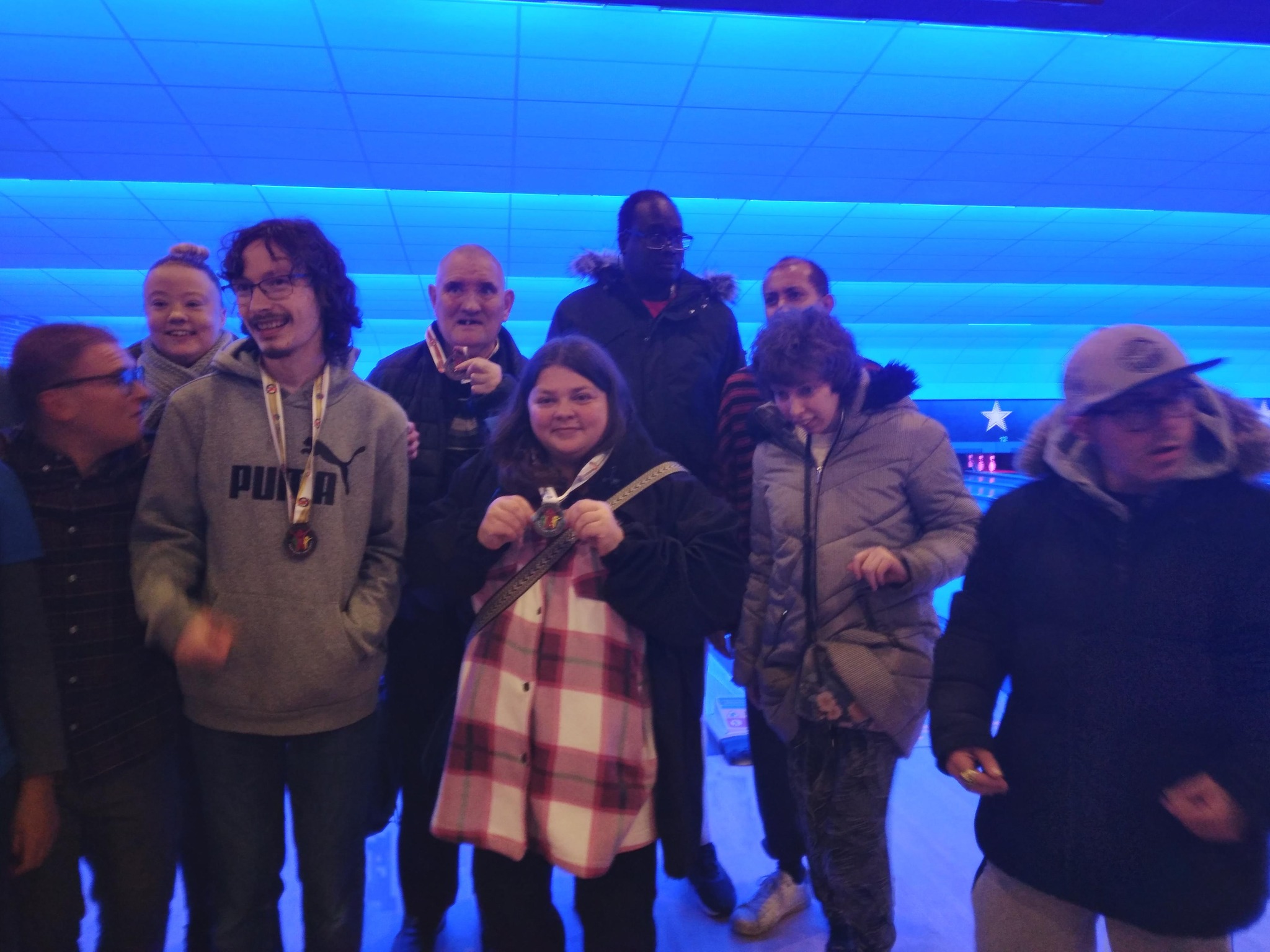 Residents in front of a bowling alley