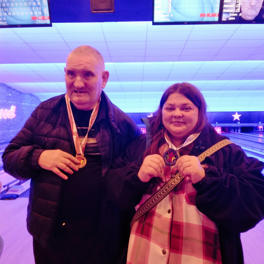 Residents in front of a bowling alley
