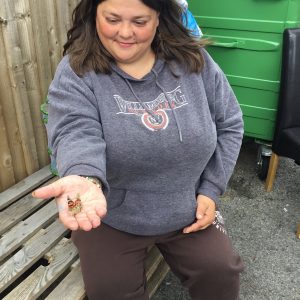 resident with butterfly on open palm