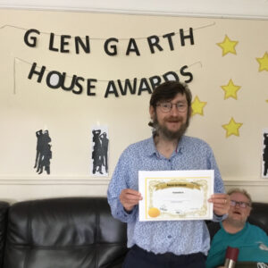 resident with award certificate