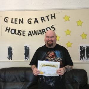resident with award certificate