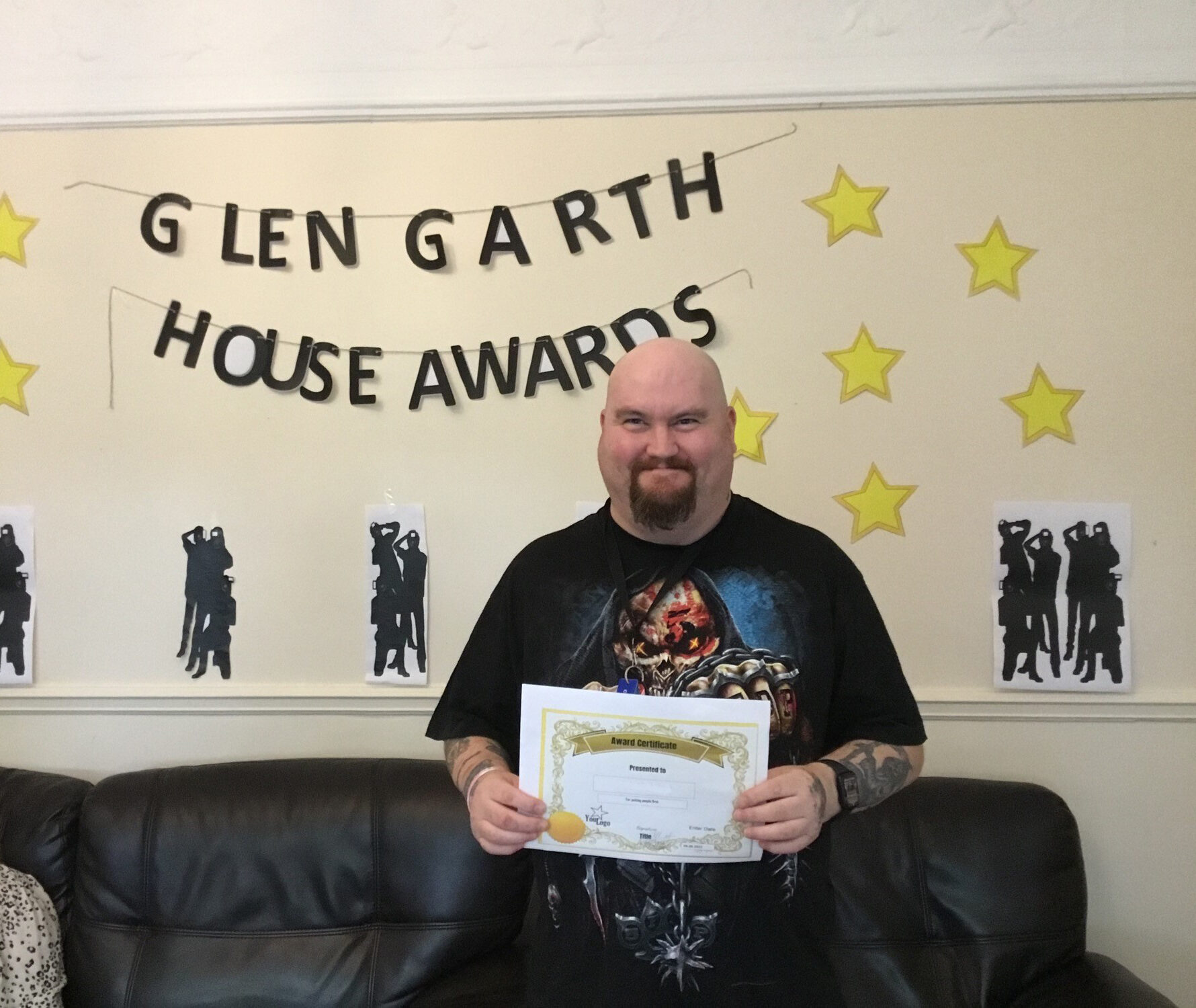 resident with award certificate