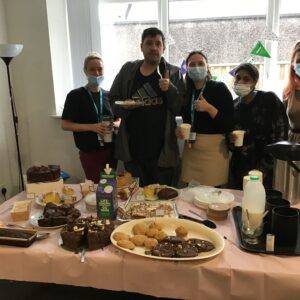 team members standing behind buffet table
