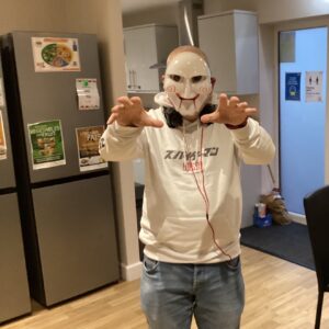 resident dressed in Halloween mask
