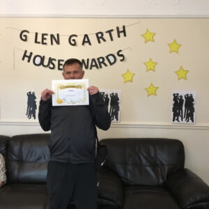 resident with award certificate