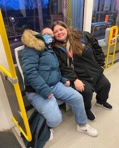 residents on the bus wearing Man City hats and scarves