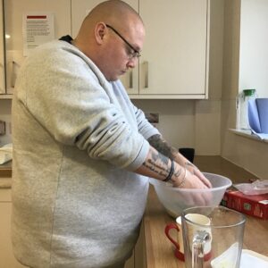 resident mixing biscuit mix in bowl