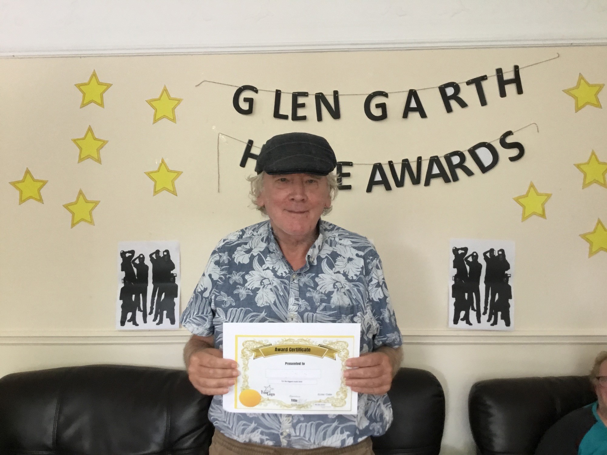 resident with award certificate