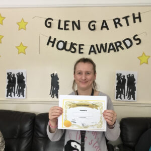 resident with award certificate