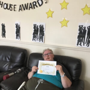resident with award certificate