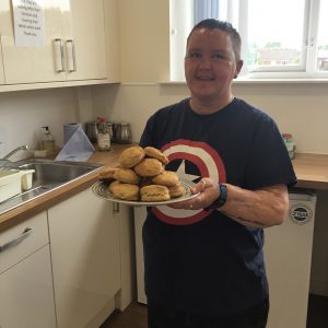 resident holding tray of home made scones