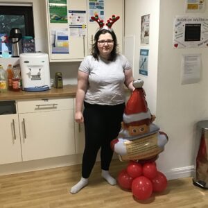 resident posing with a santa decoration