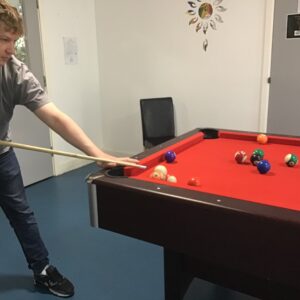 male resident playing pool