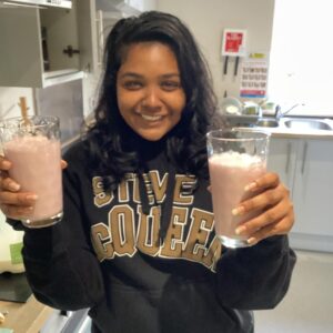 Female team member holding two milkshakes