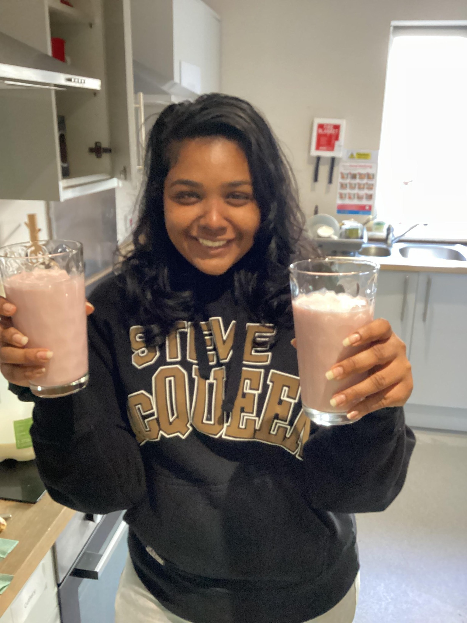 Female team member holding two milkshakes