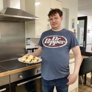 Resident holding cakes he has made