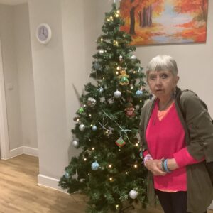 merry christmas 2021: resident with christmas tree