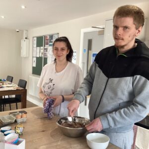male and female prepping cupcakes