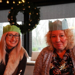 residents and staff in paper party hats